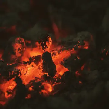 Coals glowing under grey ash