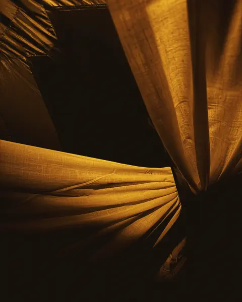 Folds of cloth in warm light