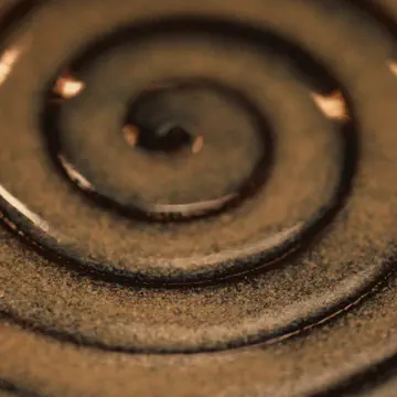 A spiral pressed into glazed clay