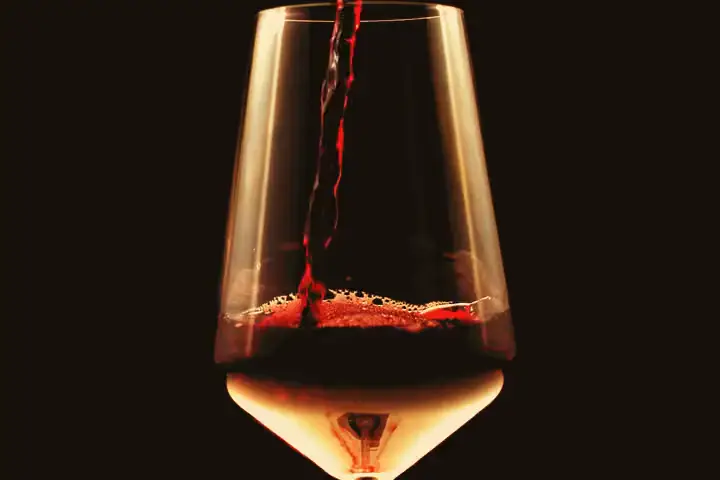 Red wine poured into a glass